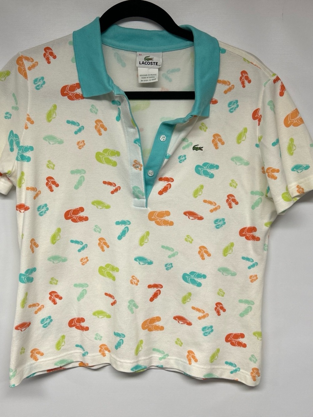 Lacoste White Short-Sleeve Polo with Aqua Collar and Multicolor Flip-Flop Print